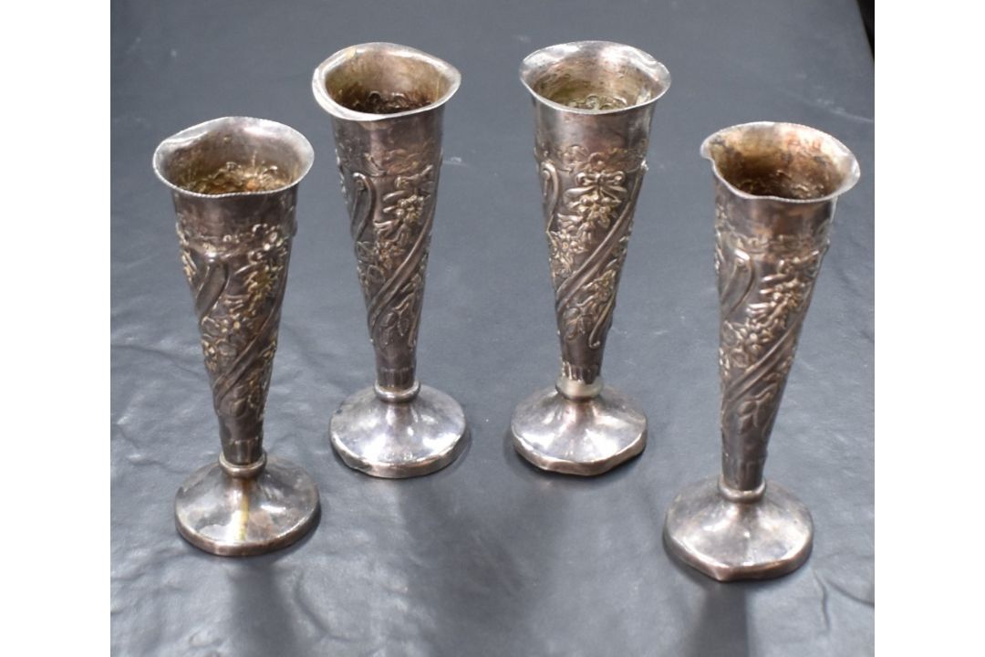A group of four Victorian and Edwardian silver vases, of fluted form having embossed floral and - Image 1 of 2
