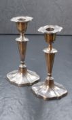 A pair of Victorian silver candlesticks, of traditional form having lozenge sconces over fluted