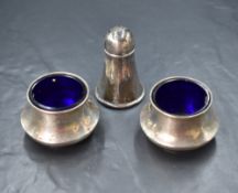 A pair of George V silver salts, of squat bulbous form with blue glass liners, marks for