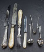 A Victorian silver knife and fork set, having foliate and scroll engraving to the silver with carved