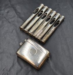 An Edwardian silver novelty cigarette holder, modelled as a rifle magazine, marks for Birmingham