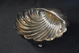 An Edwardian silver shell motif bowl, raised on three ball feet, marks for Sheffield 1904, maker