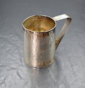 An Elizabeth II silver Christening cup, of traditional form having an angular handle and 'CLM'