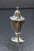 A George V silver pepperette, of traditional form having canted sides, raised on a circular foot,