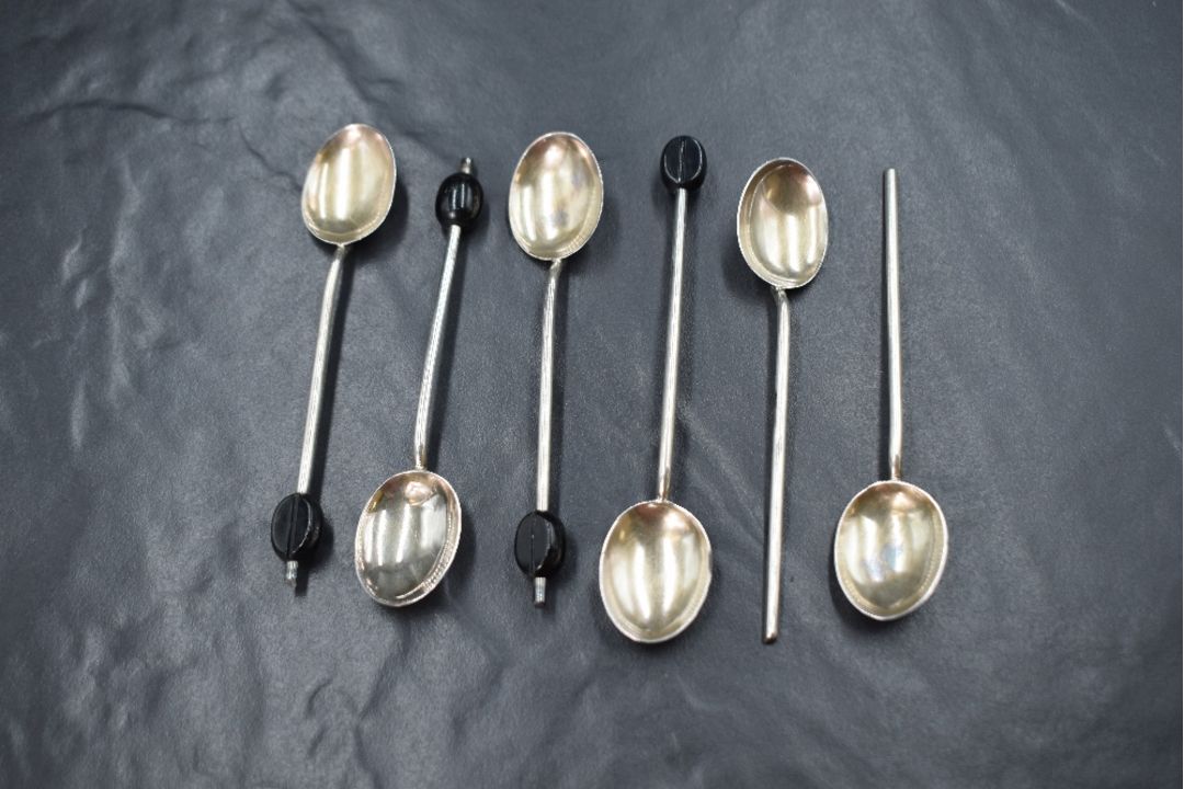 A cased set of six George V silver coffee bean spoons, having black 'beans' to terminals, two - Image 1 of 2