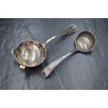 A Victorian silver sugar sifter, of traditional form having scroll decoration to terminal, along