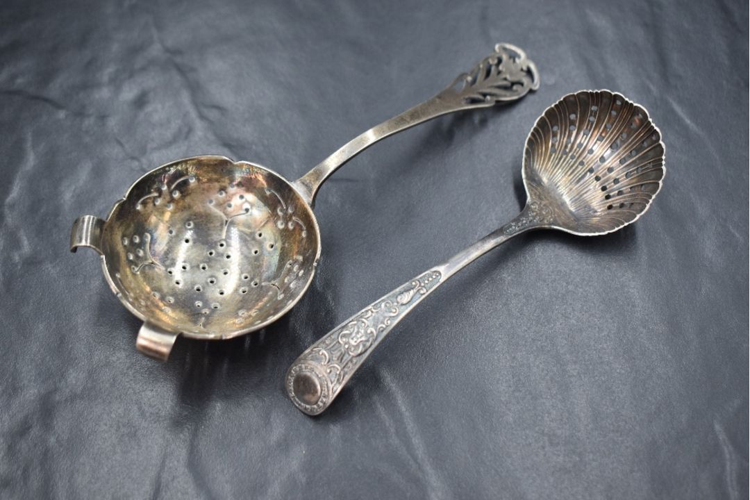 A Victorian silver sugar sifter, of traditional form having scroll decoration to terminal, along - Image 1 of 3