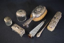 A Victorian Silver hairbrush having berry and floral decoration with scroll work and dog study to