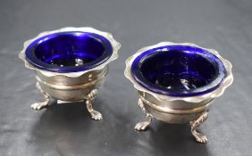 A pair of Edwardian silver salts, of circular form having lobed rims, raised on three cabriole style