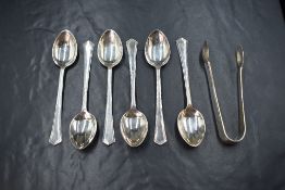 A cased set of six George VI silver teaspoons, having angular terminals along with a pair of sugar
