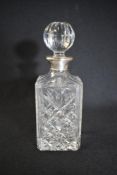 An Elizabeth II silver mounted glass decanter, of square form having a silver mounted neck with