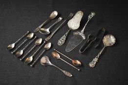 A pair of George V silver sugar tongs, having engraved scroll and diaper decoration, marks for