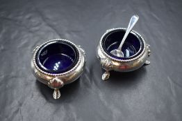 A pair of Victorian silver salts, of circular form having bead thread, raised on three hoof motif