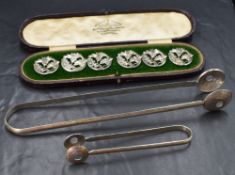 A cased set of six white metal 800. grade buttons, of circular form having pierced floral