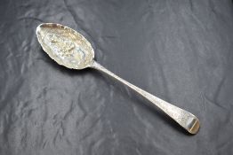 A George III silver berry spoon, having floral decoration to the bowl and terminal, with a vacant