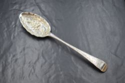 A George III silver berry spoon, having floral decoration to the bowl and terminal, with a vacant