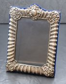 An Elizabeth II silver mounted photograph frame, having gadrooned and scroll decoration with a