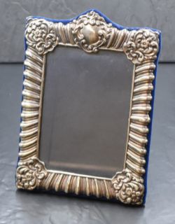 An Elizabeth II silver mounted photograph frame, having gadrooned and scroll decoration with a