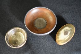 A George V silver mounted wooden alms dish, having a silver mounted rim and a central circular panel