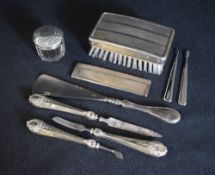 A 20th century silver mounted vanity set, comprising manicure items, shoe horn and a silver topped