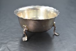 A George V silver sugar bowl, having a Chippendale style rim, raised on three knopped feet, marks