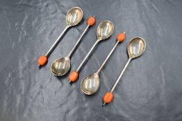 A cased group of five George VI silver coffee bean spoons, having orange 'beans', marks for