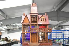 An impressive Victorian French-style wooden house-formed birdcage, featuring a central removable