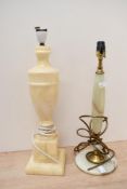 Two 20th-century hardstone lamp bases, to feature an onyx and brass example with a larger urn-formed