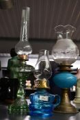 A small selection of late 19th to early 20th-century glass and brass oil lamps, to feature a