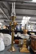 A tall late 19th to early 20th-century brass oil lamp, having a Corinthian column base with