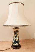 A Moorcroft pottery 'Lamia' table lamp, featuring tube-lined water lily and bullrush detailing,