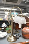 A contemporary Victorian-style metal swan neck table lamp, featuring a reeded column base and a