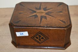 An early 20th-century wooden marquetry inlaid money box, of octagonal form, featuring star/compass