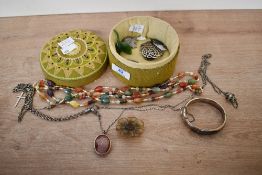 A collection of costume jewellery to include a silver hinged bangle, silver brooches and an agate