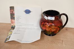 A mid-20th-century William Moorcroft 'African Lily' ewer-form vase, decorated with tube-lined floral