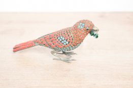 A fine 20th-century Tibetan–Nepalese brass bird ornament, richly inlaid with red coral and