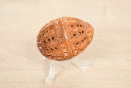 A small late 19th to early 20th-century hand carved coquilla nut, having intricate carvings and a