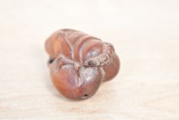 A small 20th-century Japanese boxwood netsuke, of Cicada-form upon a fruit branch, character marks