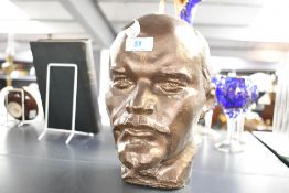 A vintage pottery bust of Vladimir Lenin, having a bronze-like finish, unmarked, 25cm in height,
