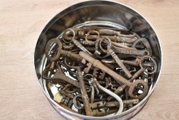 A quantity of 19th and 20th-century metal keys and cork screws, of varying styles, cuts and