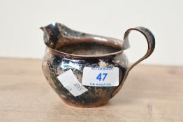 A 20th-century Arts and Crafts Keswick School of Industrial Art (KSIA) silver-plated copper milk