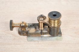 A small late 19th-century Joseph Casartelli of Manchester brass microscope cloth counting glass,