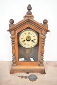 A late 19th-century to early 20th-century American Ansonia steeple-style wooden mantel clock,