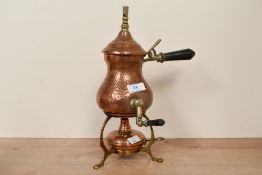 A late 19th to early 20th-century hammered copper samovar, featuring brass detailing, an ebonised