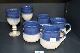 A quantity of vintage Ammerdown studio pottery, to feature four mugs and two goblets having a blue