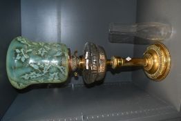 A fine and unusual Victorian brass oil lamp, having a moulded uranium glass shade with thistle