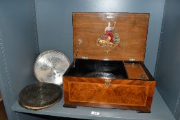 A late 19th to early 20th-century B.H. Abrahams Swiss Britannia disk music box, housed in a burl