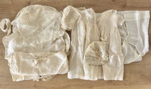 Antique baby items in cream silk, cotton and lace, comprising a silk dress with cotton under