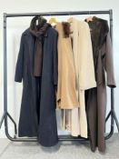 A collection of vintage wool blend coats with fur or faux fur details and accessories, to include