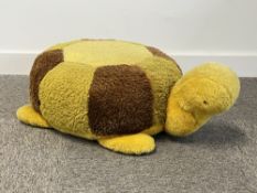 A vintage turtle shaped footstool / footrest in earthy green, brown and yellow, wool mix fur,